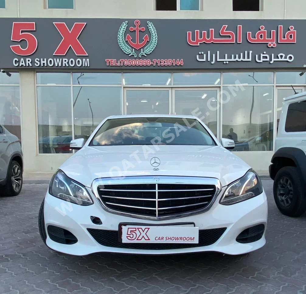 Mercedes-Benz  E-Class  200  2014  Automatic  186,000 Km  4 Cylinder  Rear Wheel Drive (RWD)  Sedan  White