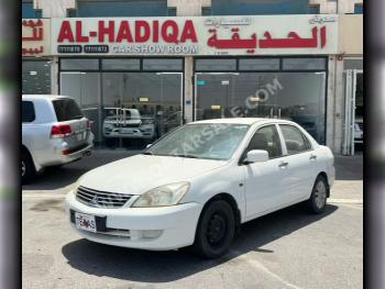 Mitsubishi  Lancer  2014  Manual  298,000 Km  4 Cylinder  Front Wheel Drive (FWD)  Sedan  White