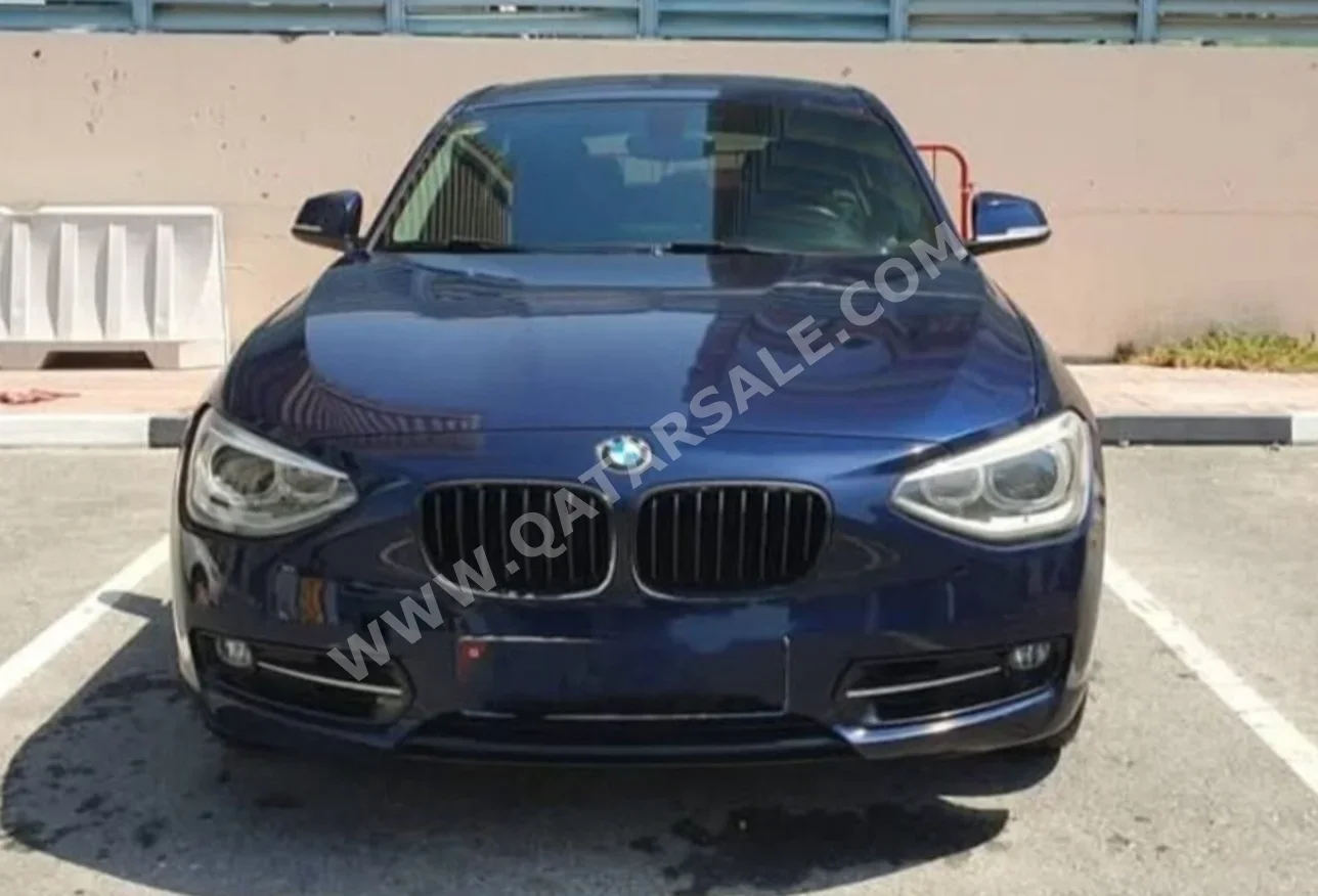 BMW  1-Series  118i  2015  Automatic  142,000 Km  4 Cylinder  Rear Wheel Drive (RWD)  Hatchback  Dark Blue  With Warranty