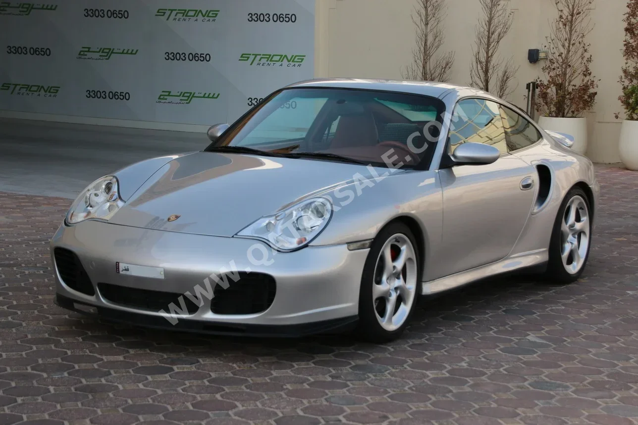بورش  911  توربو  2003  اوتوماتيك  102,000 كم  6 سلندر  دفع خلفي  كوبيه \ سبورت  فضي