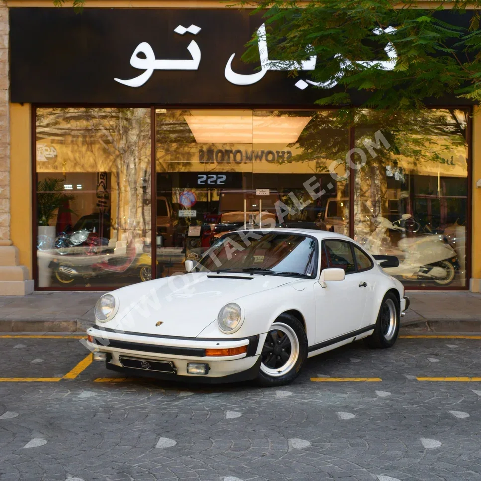 بورش  911  1983  عادي  91,750 كم  6 سلندر  دفع خلفي  كوبيه \ سبورت  أبيض
