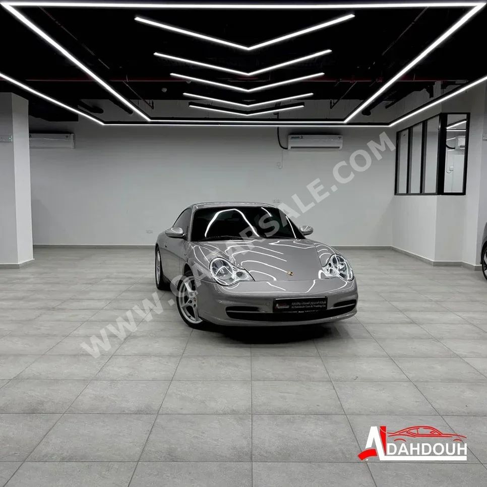 بورش 911 كاريرا 2002 اوتوماتيك 27,000 كم 6 سلندر دفع خلفي كوبيه \ سبورت ذهبي