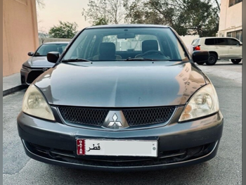 متسوبيشي لانسر 2007 اوتوماتيك 300,000 كم 4 سلندر سيدان رمادي غامق تحت الضمان