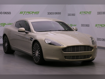 Aston Martin  Rapide  2013  Automatic  36,000 Km  12 Cylinder  Rear Wheel Drive (RWD)  Coupe / Sport  Gold