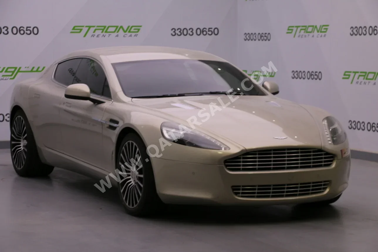 Aston Martin  Rapide  2013  Automatic  36,000 Km  12 Cylinder  Rear Wheel Drive (RWD)  Coupe / Sport  Gold